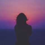 夕暮れに一人立つ女性