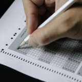 白い紙に向かって手を動かす人