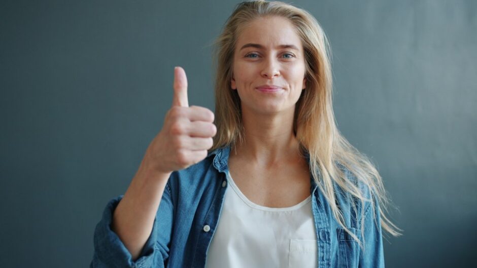 smiling woman giving a thumbs up