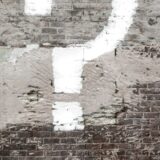 question mark painted on a brick wall