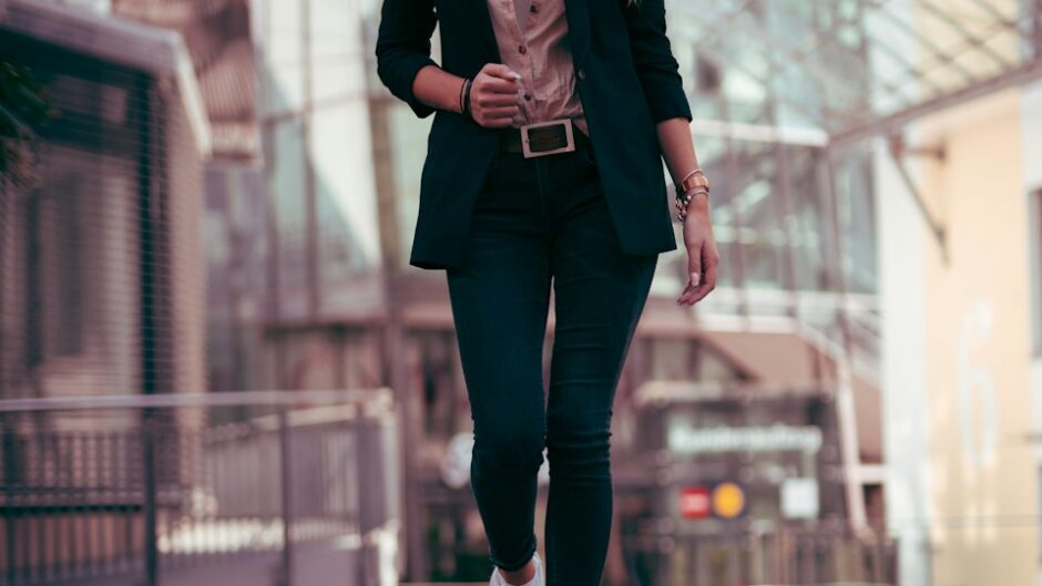 confident woman in a black blazer standing outdoors