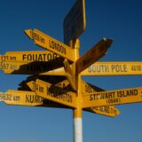 signpost with several arrows pointing different ways