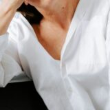 woman holding her hands to her face under pressure