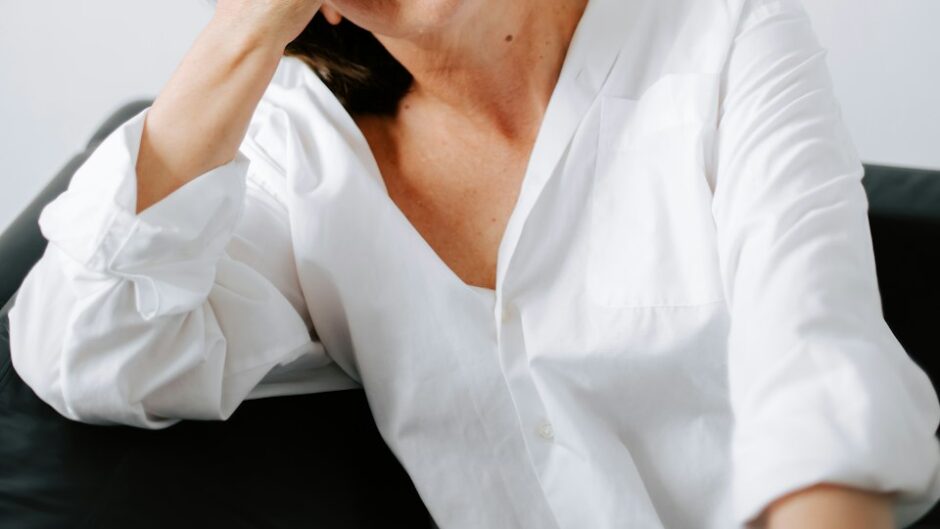 woman holding her hands to her face under pressure