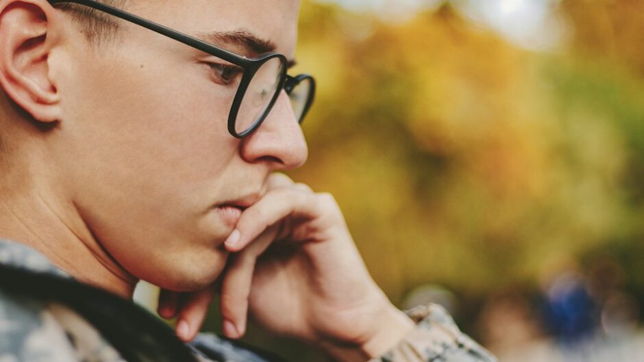 boy holding his face while thinking hard