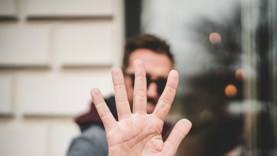 man raising his hand to say stop