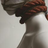 mannequin head wrapped in rope, feeling restricted