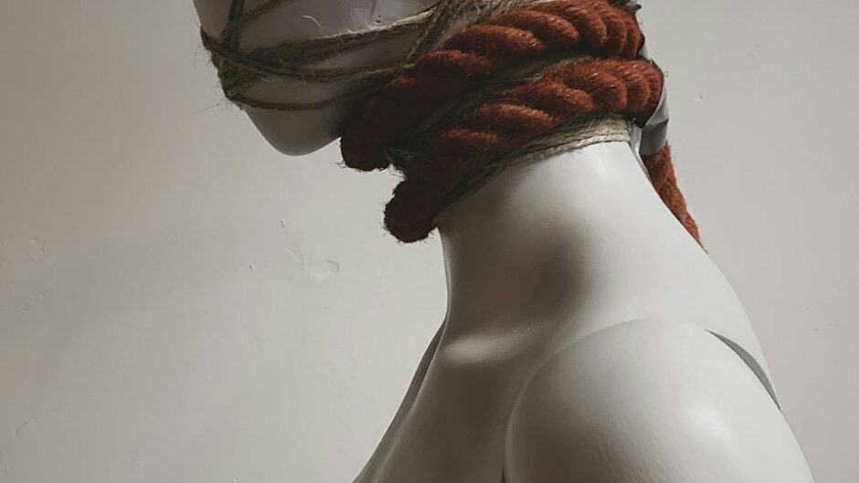 mannequin head wrapped in rope, feeling restricted