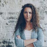 woman with arms crossed showing disapproval